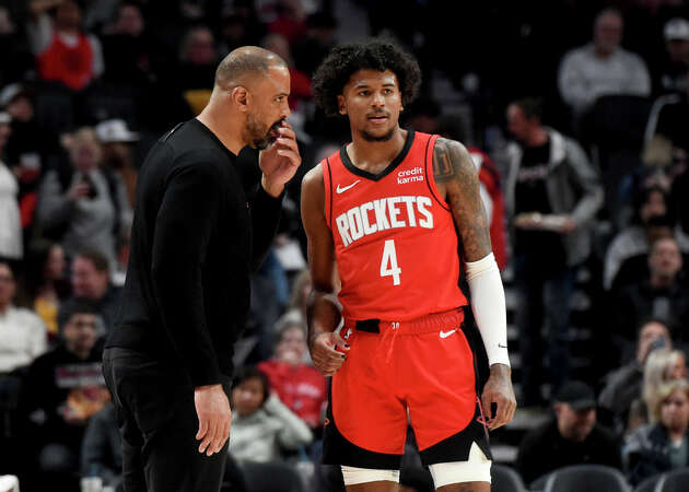 Houston Rockets head coach Ime Udoka, left, speaks with Houston Rockets guard Jalen Green (4) during the first half of an NBA basketball game against the Portland Trail Blazers in Portland, Ore., Friday, March 8, 2024. 