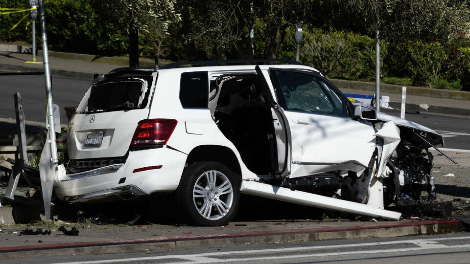 Police secure an area around West Portal Station after a fatal car crash involving an SUV in San Francisco on Saturday, March 16, 2024. According to the San Francisco Fire Department, two individuals were killed and three are injured.