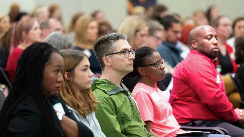 People listen to public speakers during a Houston ISD Board of Managers meeting at the Hattie Mae White Educational Support Center, Thursday, March 21, 2024, in Houston. One hundred and fifty members of the public signed up to speak at the meeting.