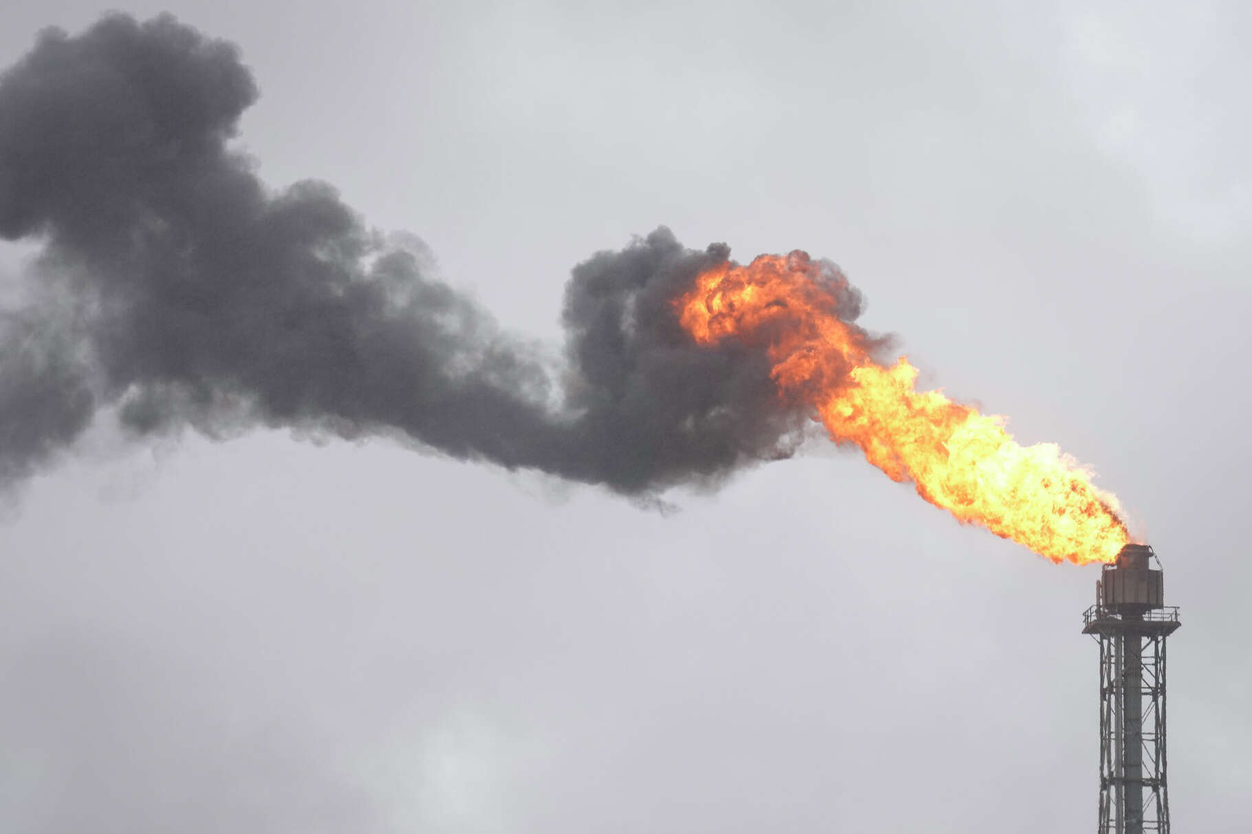 Flare and black smoke are seen from a chemical plant from Texas Highway 225 Thursday, March 21, 2024 in Deer Park.