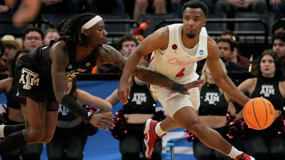 Houston Cougars guard L.J. Cryer (4) is fouled by Texas A&M Aggies guard Manny Obaseki (35) during the second half of a college basketball game in the second round of the men's NCAA Tournament at FedExForum on Sunday, March 24, 2024, in Memphis, Tenn.