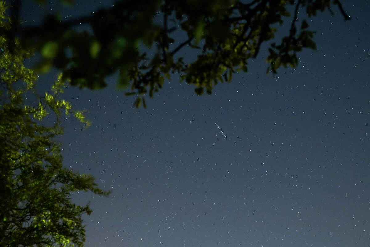 A satellite from a larger group of satellites called Starlink can be seen trailing across the night sky over Saltburn on April 21, 2020 in Saltburn By The Sea, United Kingdom. 