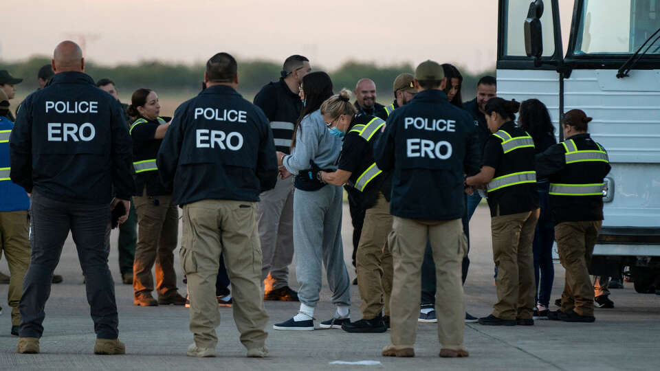 A woman in shackles is patted down before boarding the first deportation flight of undocumented Venezuelans after a US-Venezuelan agreement in Harlingen, Texas, on Oct.18, 2023. The United States said on Oct. 5, 2023, it will resume deportation flights to Venezuela after a deal with Caracas, as President Joe Biden, seeking reelection, comes under pressure to halt border crossings. Washington has for years halted sending migrants back to Venezuela due to instability in the South American nation and still maintains sanctions against the government of President Nicolas Maduro. (Veronica G. Cardenas/AFP/Getty Images/TNS)