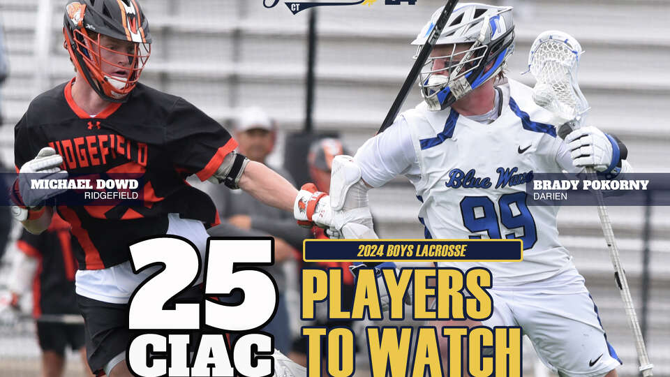 Darien's Brady Pokorny (99) and Ridgefield's Michael Dowd (25) go head-to-head during a CIAC Class L boys lacrosse quarterfinal game in Darien on Saturday, June 3, 2023.