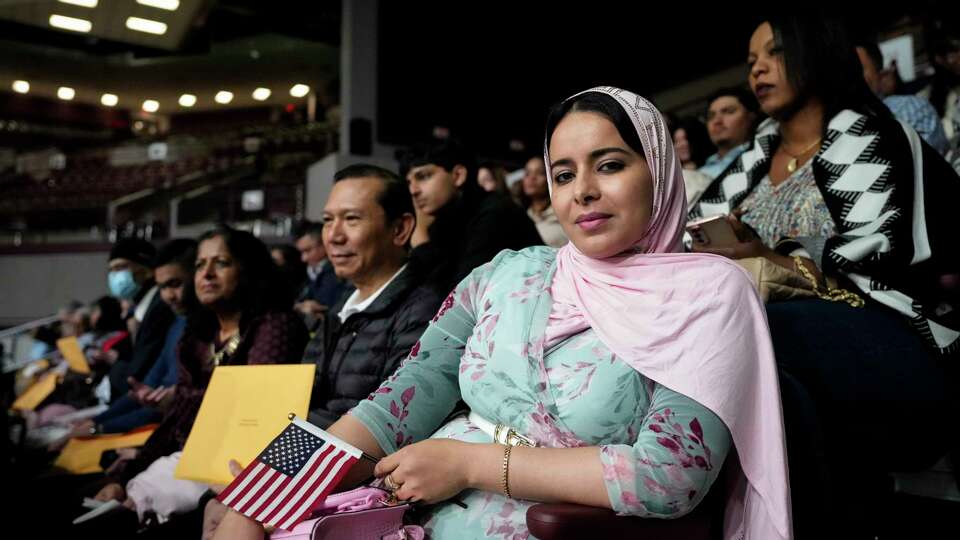 Fatima Jouhari waits to receive her naturalization certificate after the ceremony Wednesday, March 27, 2024 at M.O. Campbell Educational Center in Houston. Jouhari, originally from Morocco, was among more than 1300 Houston-area residents became naturalized citizens Wednesday.