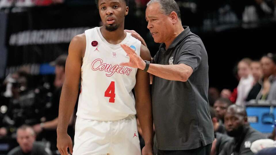 Houston head coach Kelvin Sampson, right, talks with guard L.J. Cryer during the first half of a Sweet 16 men's college basketball game in the NCAA Tournament on Friday, March 29, 2024, in Dallas.