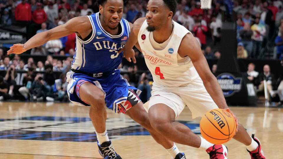 Houston guard L.J. Cryer (4) drives the ball against Duke guard Jeremy Roach (3) during the second half of a Sweet 16 men's college basketball game in the NCAA Tournament on Friday, March 29, 2024, in Dallas.