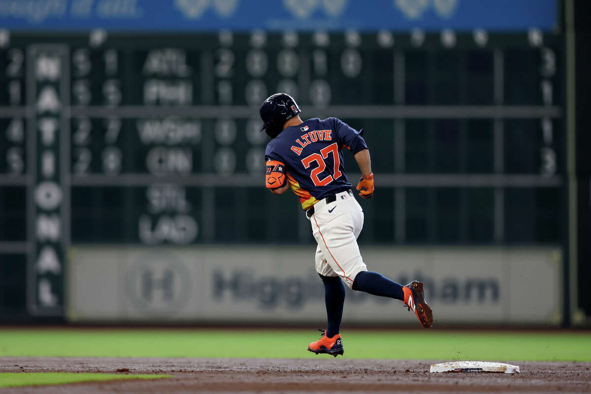 Jose Altuve #27 of the Houston Astros hits a solo home run in the third inning against the New York Yankees at Minute Maid Park on March 31, 2024 in Houston, Texas. 