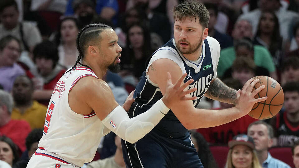 Houston Rockets forward Dillon Brooks (9) drives to defend Dallas Mavericks guard Luka Doncic (77) at Toyota Center on Sunday, March 31, 2024 in Houston.