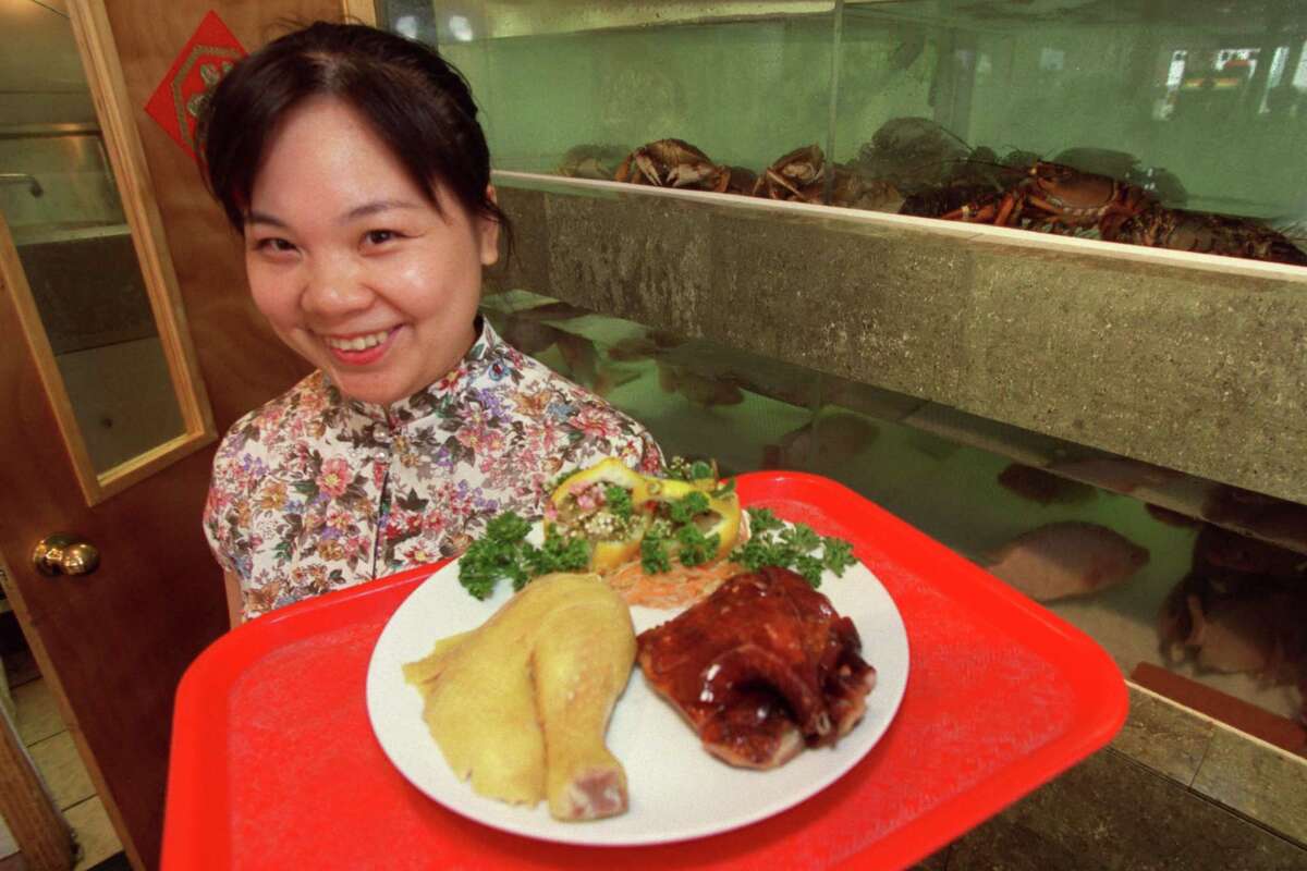 CONTACT FILED: HONG KONG FOOD STREET The Hong Kong Food Street at 9750 Bellaire Blvd. Connie Hong, server with chicken and duck appetizers, at back are live fish tanks. Photographed Wednesday April 15, 2003, for the Dining Guide. Chronicle/DeSoto. COVER STORY / A taste of Hong Kong / Longing for flavors of his homeland, newcomer to Houston creates his own HOUCHRON CAPTION (06/27/2003): A newcomer to Houston couldn't find tastes from his native land, so he opened a restaurant. DINING GUIDE. HOUCHRON CAPTION (06/27/2003): Connie Hong serves up chicken and duck appetizers while live crabs and other seafood look on.