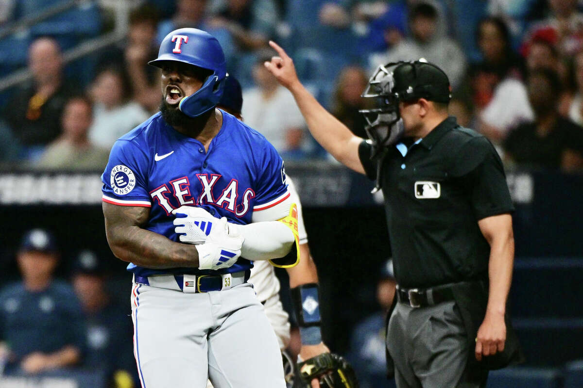 Adolis Garcia #53 of the Texas Rangers reacts after getting hit by a pitch thrown by Phil Maton (not pictured) of the Tampa Bay Rays in the ninth inning at Tropicana Field on April 01, 2024 in St Petersburg, Florida.