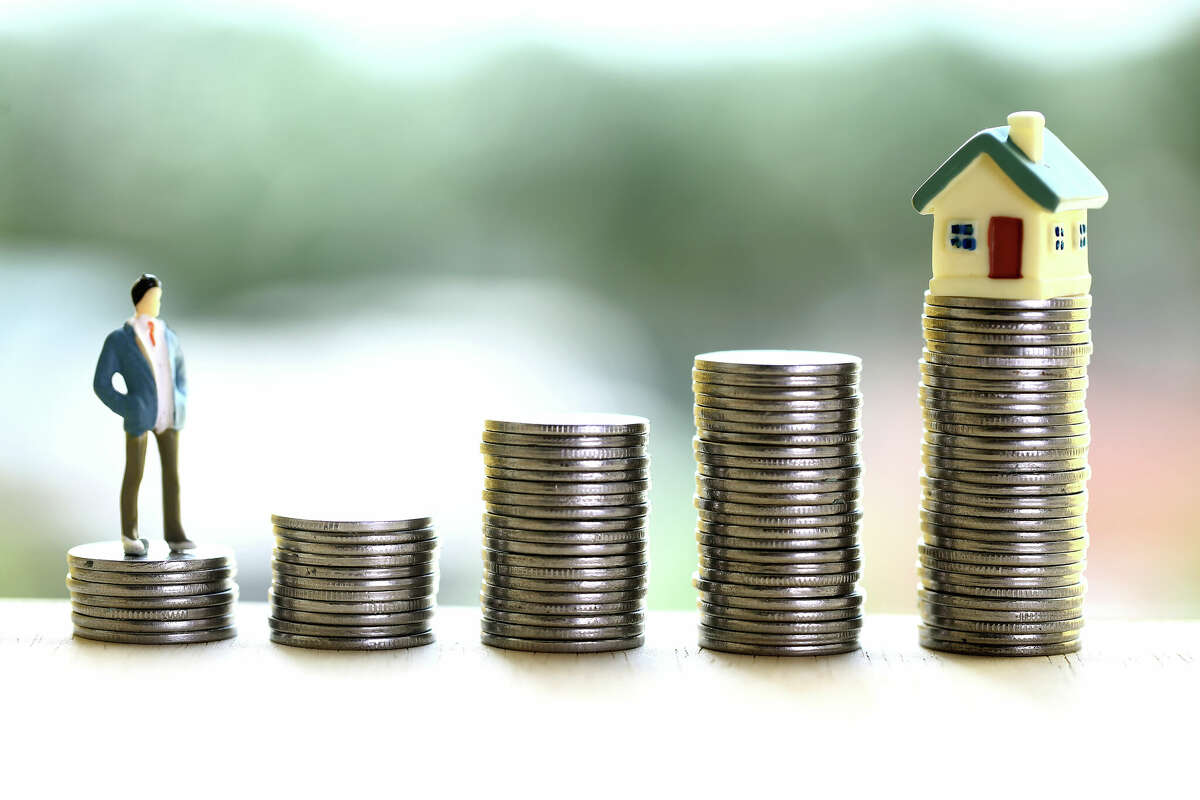 Concept of money savings and own house purchase-Stack of coins