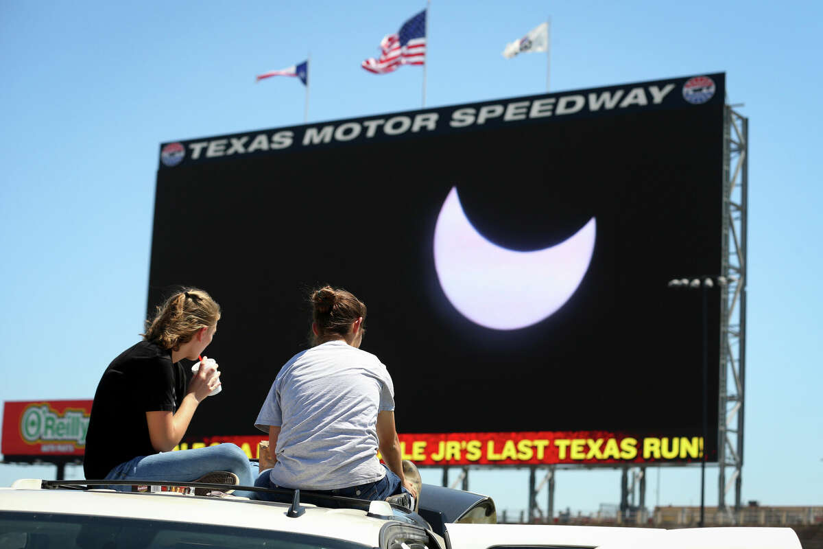 Spectators watch the solar eclipse as it is broadcast on Big Hoss at Texas Motor Speedway on August 21, 2017 in Fort Worth, Texas. Millions of people have flocked to areas of the U.S. that are in the 'path of totality' in order to experience a total solar eclipse.