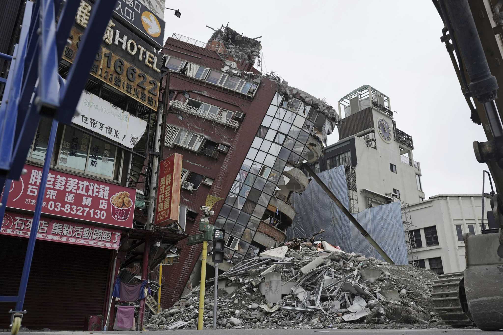 Earthquake aftershocks halt the demolition of a leaning building in