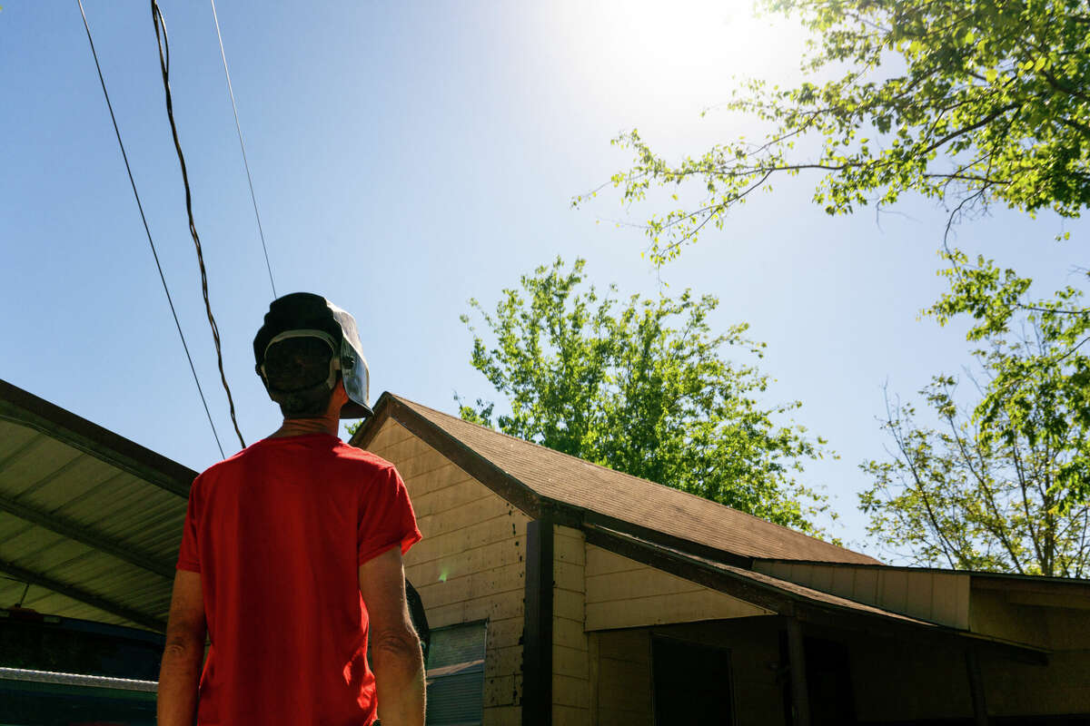 Scott Eric Schindler watches the annular solar eclipse from his backyard on October 14, 2023 in Kerrville, Texas.