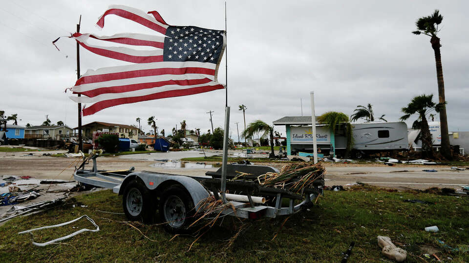 A tattered U.S. flag blows in the wind in the aftermath of Hurricane Harvey in Port Aransas, Texas on Sunday, Aug. 27, 2017. (Kin Man Hui/San Antonio Express-News)