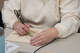 A senior burns an outline of a flower onto a piece of wood during a wood burning workshop at the Mecosta County Senior Center in 2024. Here are some other activities designed for seniors in mind. (Pioneer file photo)
