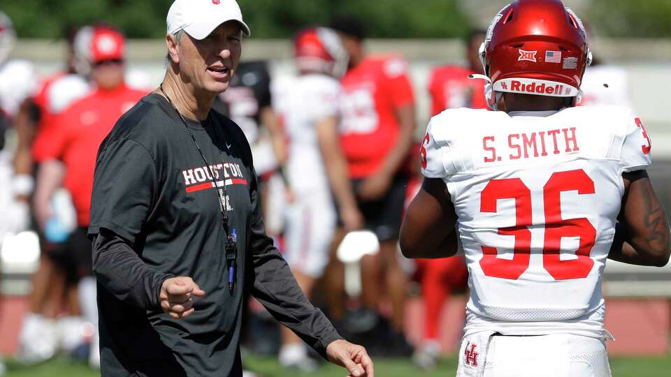 Head coach Willie Fritz, left, talks with linebacker Sherman Smith (36) during the University of Houston Spring Football game, held at the Carl Lewis International Complex Saturday, Apr. 13, 2024 in Houston.