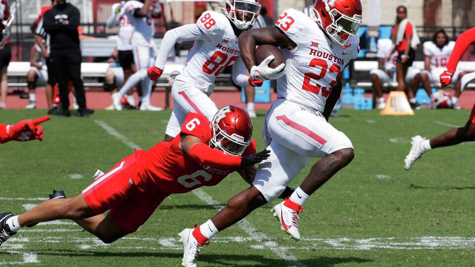Running back Parker Jenkins (23) breaks the tackle attempt by defensive back Noah Guzman (6) during the University of Houston Spring Football game, held at the Carl Lewis International Complex Saturday, Apr. 13, 2024 in Houston.