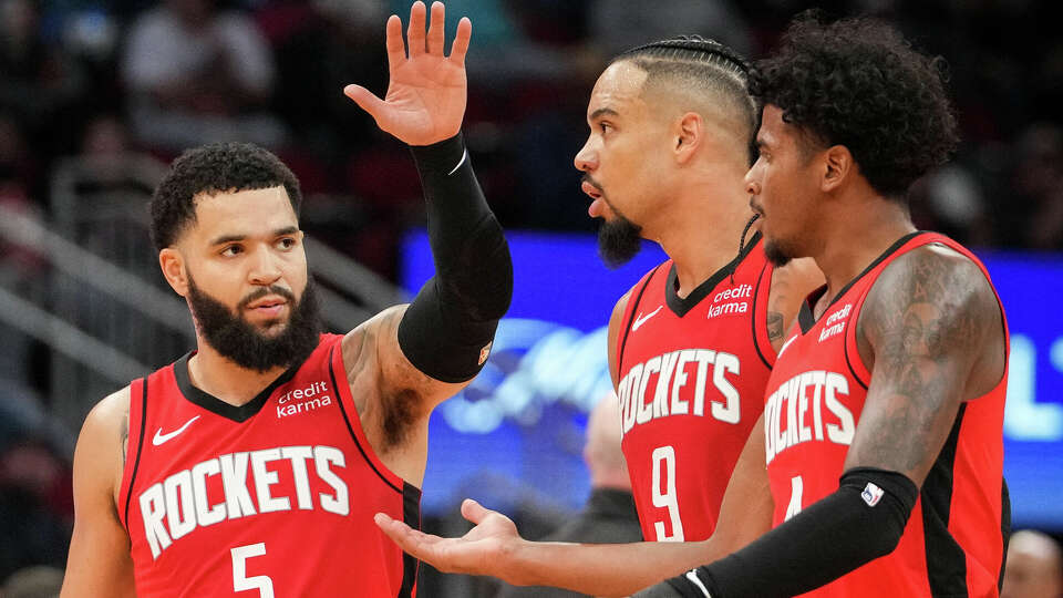 Houston Rockets guard Fred VanVleet (5) high-fives forward Dillon Brooks (9) and guard Jalen Green (4) during the second half of an NBA game Wednesday, Nov. 1, 2023, at the Toyota Center in Houston.