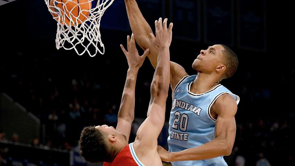 Indiana State's Jayson Kent dunks over Bradley's Malevy Leons during an NCAA college basketball game on Saturday, Jan. 27, 2024 in Terre Haute, Ind. (Joseph C. Garza/The Tribune-Star via AP)