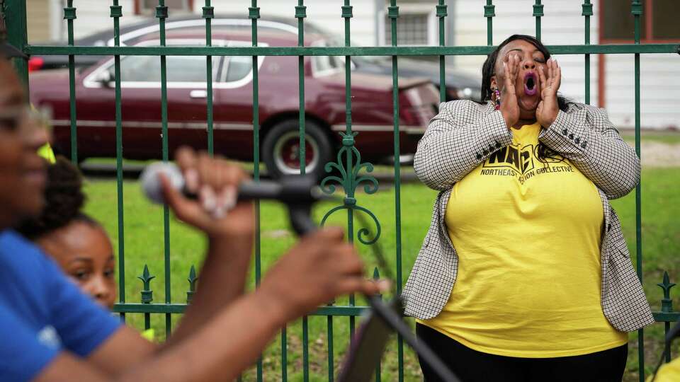 Sade Hogue cheers during a press conference calling for action to repair old private sewage lines Tuesday, April 16, 2024, at her in Houston.