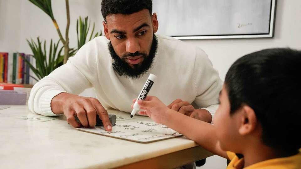 Former kindergarten teacher Spencer Russell, 34, who developed program gaining popularity called Toddlers Can Read, has a lesson with Essa Suleman, 4, on Wednesday, April 17, 2024, in Houston .