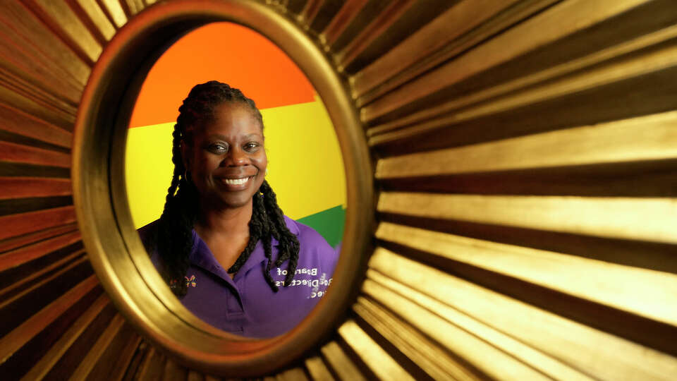 Kendra Walker, president of Pride Houston, is shown reflected in a mirror Thursday, April 11, 2024, in Houston.