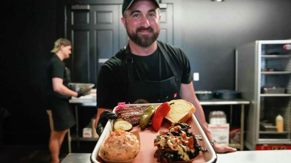 Pit master Leonard Botello makes a barbecue plate at Merritt Meat Company on Friday, April 19, 2024, in Round Top .