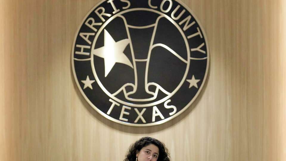 Harris County Judge Lina Hidalgo, standing with her desk, is photographed during the commissioners court meeting in the new chamber on the first floor Tuesday, April 23, 2024 at Harris County Administration Building in Houston.