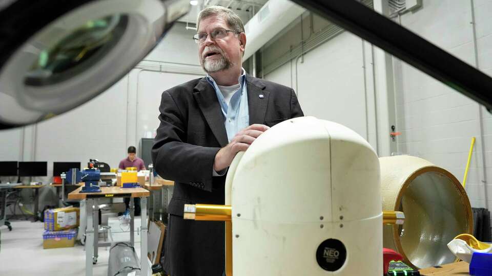 Robert Ambrose, a former NASA engineer focused on robotics and deputy director of the Texas A&M Space Institute, shows the Houston Chronicle the pendulum to go inside the second generation of RoboBall that he and students at the institute have been working on Monday, April 22, 2024 at RELLIS campus in Bryan. RoboBall was designed to be deployed to a Moon crater, which is not suitable sending humans, to collect samples. The first generation of RoboBall was designed 20 years ago.