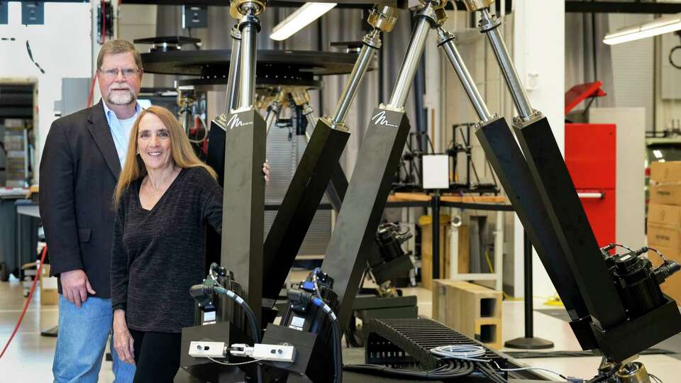 Robert Ambrose, a former NASA engineer focused on robotics and deputy director of the Texas A&M Space Institute, left, and Nancy Currie-Gregg, a former NASA astronaut and director of the Texas A&M Space Institute, pose for a photograph next to a Stewart Platform Monday, April 22, 2024 at RELLIS campus in Bryan.