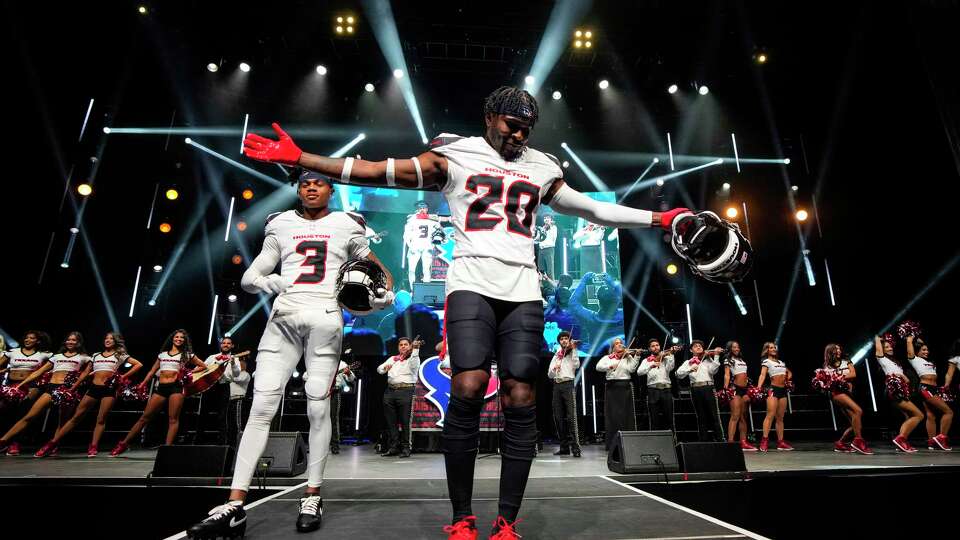 Houston Texans' Jimmie Ward, right, and Tank Dell, left, help reveal four fan-inspired uniforms during the team's release party at 713 Music Hall, Tuesday, April 23, 2024, in Houston. The team received survey results from more than 10,000 fans giving their input on what they'd like to see and hosted more than 30 focus groups with fans and players to get their feedback.
