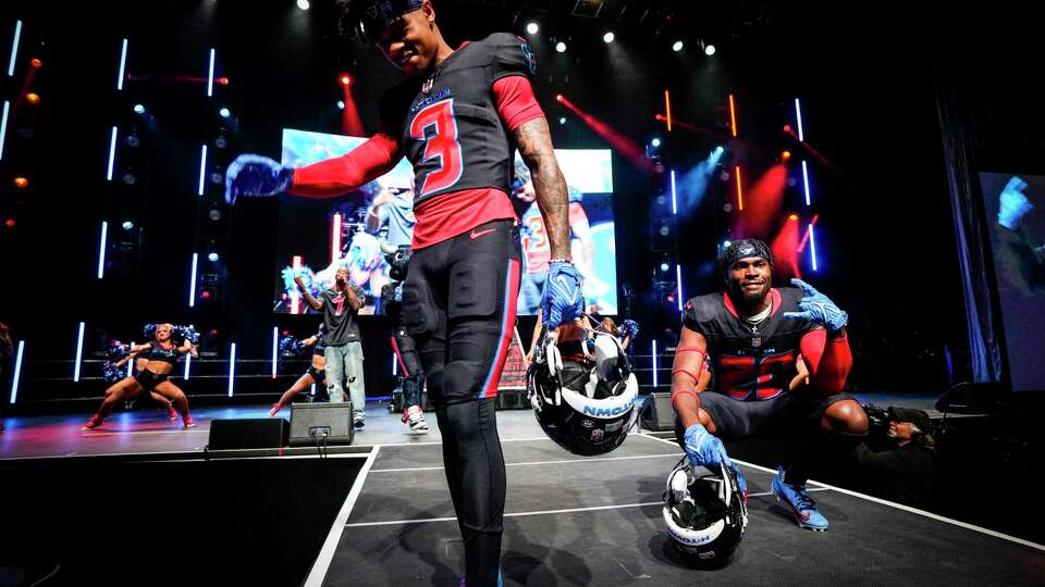 Houston Texans wide receiver Tank Dell, left, and safety Jimmie Ward show off the Texans alternate uniform as the team releases their new uniforms at 713 Music Hall Tuesday, April 23, 2024 in Huntsville. The Texans officially released four new uniforms Tuesday.