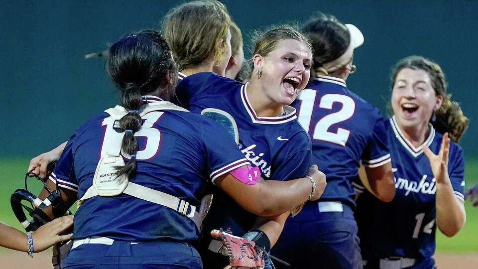 Tompkins relief pitcher Sam Crumrin, center, and teammates celebrate the team's win over Travis in a Region III-6A bi-district high school softball playoff game, Thursday, April 25, 2024, in Fulshear.