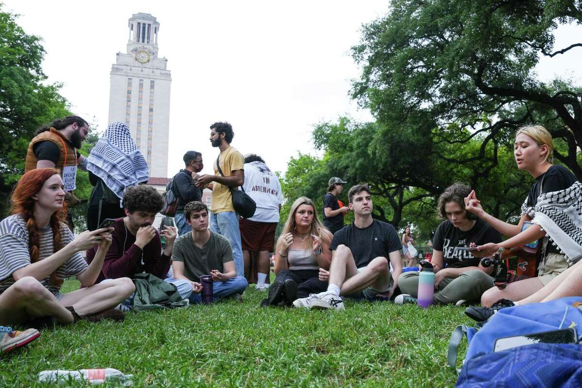 Demonstrators against the war in Gaza sing on the campus of the University of Texas at Austin, Thursday, April 25, 2024, in Austin. Students walked out of class on Wednesday as protests over Gaza continue to sweep college campuses around the country.