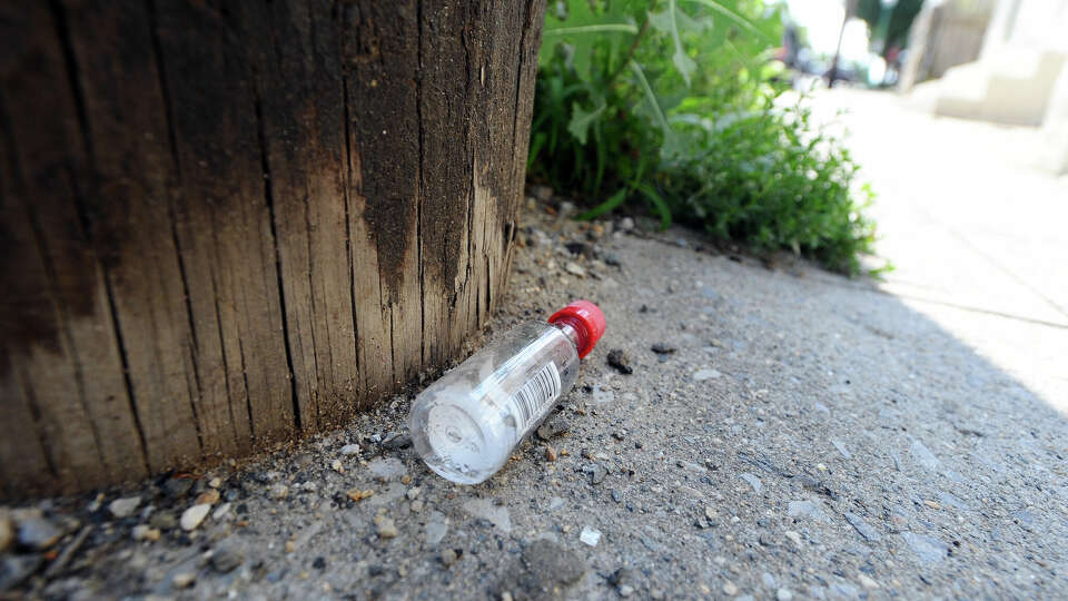 An empty nip bottle lays discarded a Connecticut street.