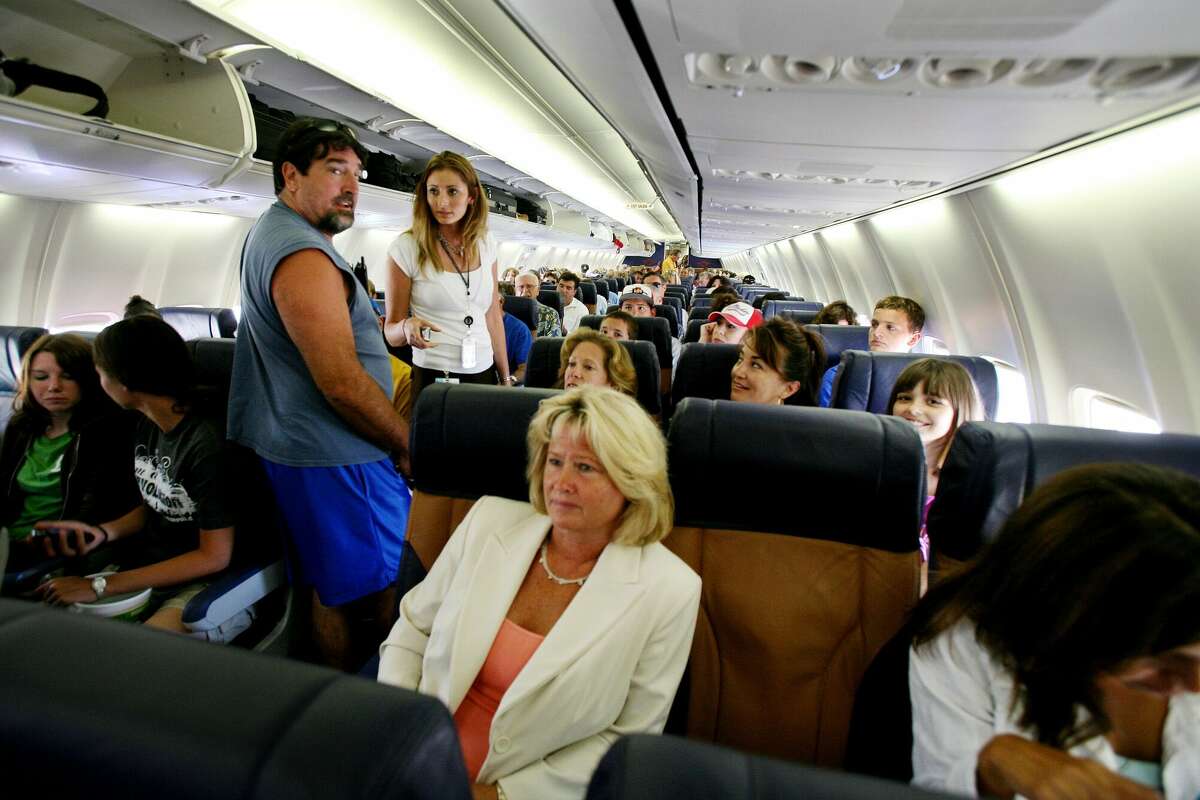 Passengers sit in their assigned seats before take-off July 10, 2006 at San Diego's Lindburgh Field Airport in San Diego, California. 