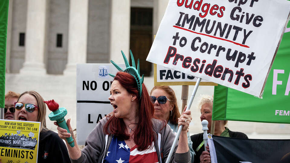 People demonstrate against Trump while the Supreme Court hears oral arguments on his claim of immunity from prosecution for alleged crimes committed during and after leaving office, Washington, DC, April 25, 2024.