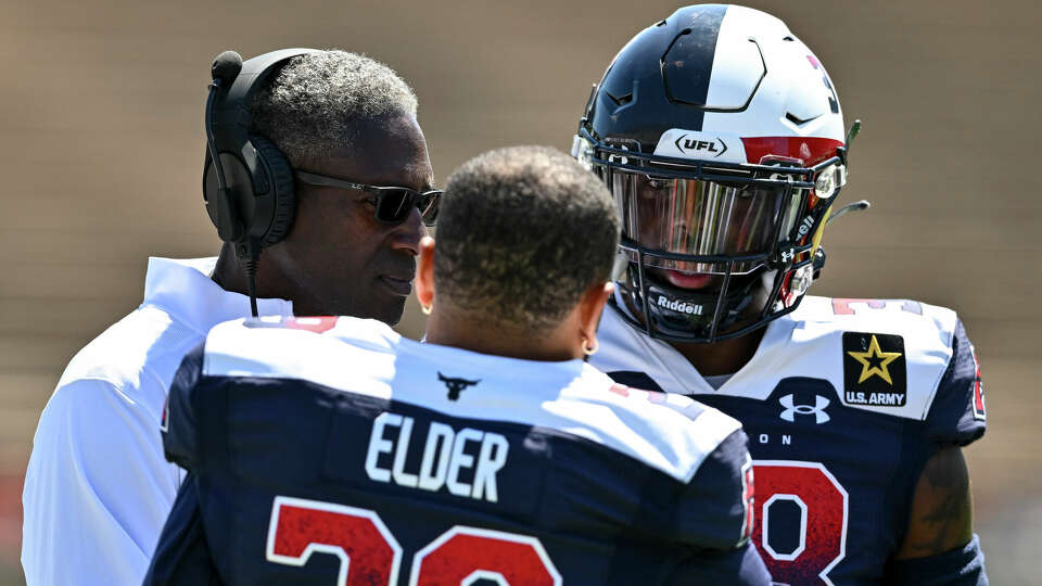 HOUSTON, TEXAS - APRIL 21: Donald Rutledge Jr. #38 speaks with defensive back coach Brett Maxie and Corn Elder #29 of the Houston Roughnecks during the second quarter against the Arlington Renegades at Rice Stadium on April 21, 2024 in Houston, Texas. (Photo by Maria Lysaker/UFL/Getty Images)