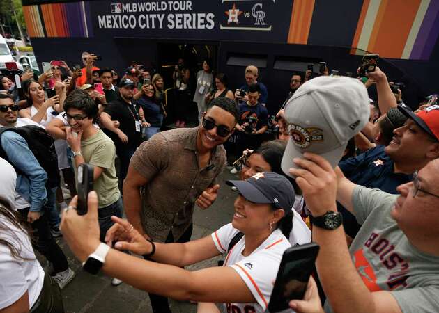 Houston Astros' Jeremy Peña poses for photos with fans during the Toco Tour promotional event at La Cibeles plaza in Mexico City, Friday, April 26, 2024. The Astros will face the Colorado Rockies in two regular season games this weekend in Mexico City. (AP Photo/Fernando Llano)