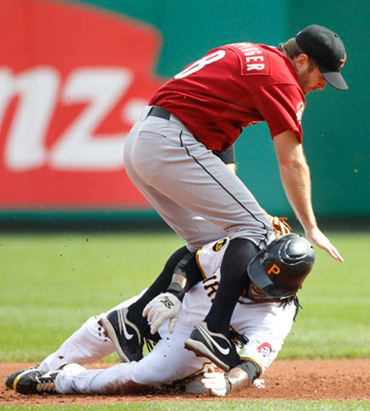 Pittsburgh's Andrew McCutchen slides into Astros second baseman Jeff Keppinger for a groundball force-out.