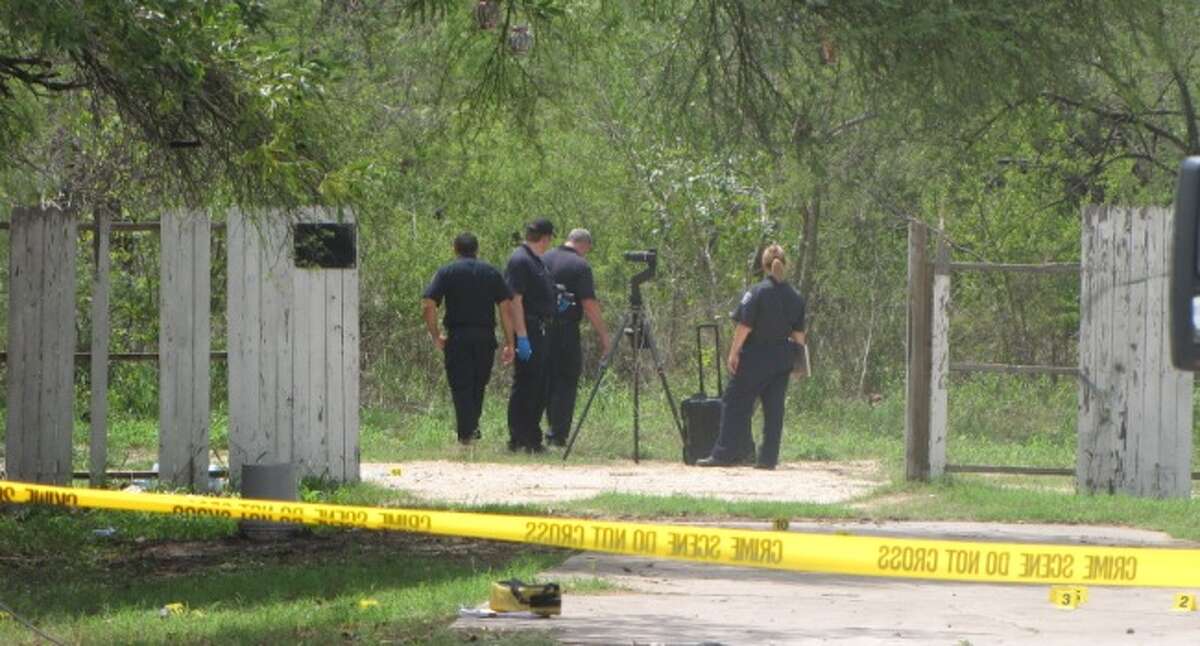 San Antonio police look for clues in the back yard of a South Side home Wednesday morning, when a man's partially decomposing body was found.