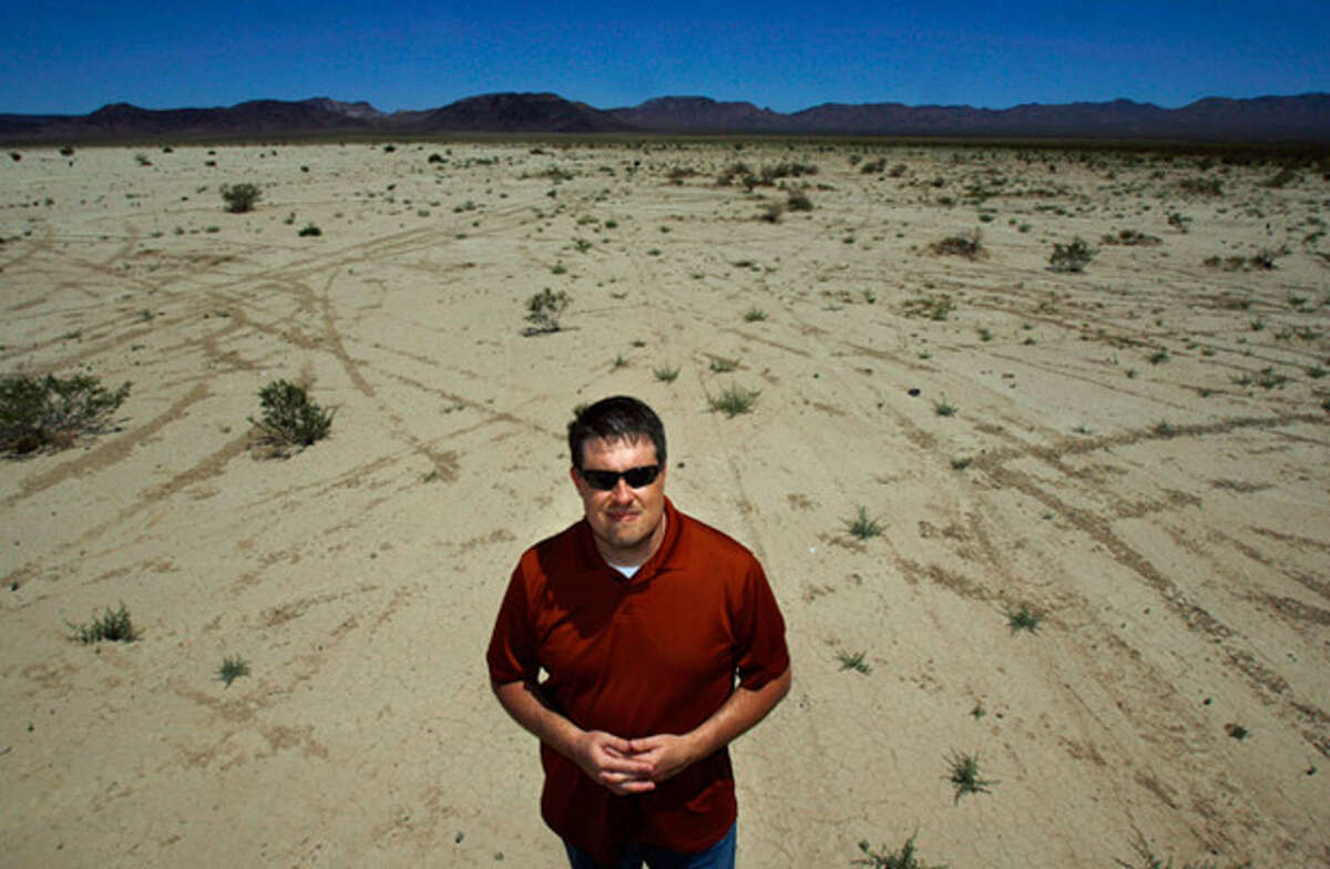 Bureau of Land Management Renewable Energy Project Manager Greg Helseth stands on the Roach Dry Lake bed in front of a proposed solar energy site near McCullough Pass, Nev.