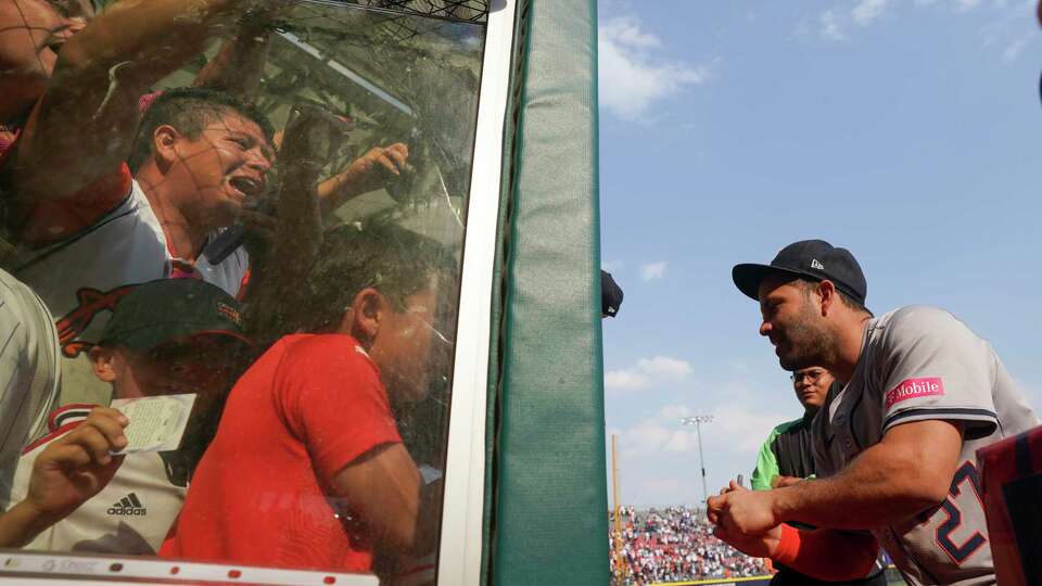 Houston Astros second baseman Jose Altuve signs autographs after beating the Colorado Rockies 8-2 during a baseball game at Alfredo Harp Helu stadium in Mexico City, Sunday, April 28, 2024. (AP Photo/Fernando Llano)