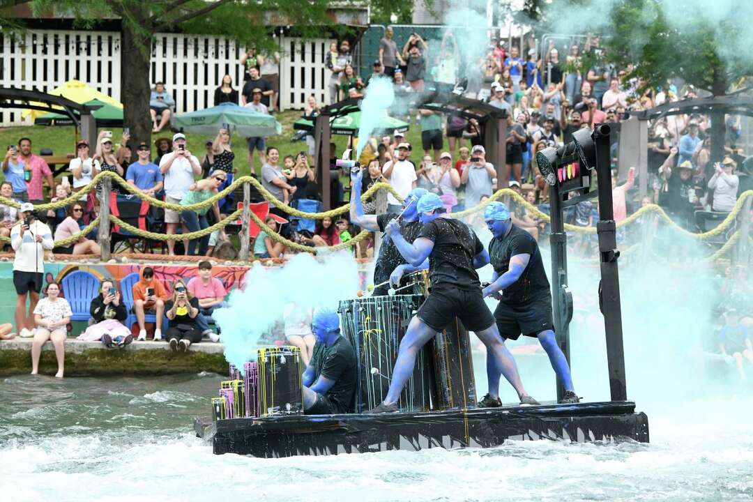 Competitors sail New Braunfels Thru the Chute Boat Race as icons