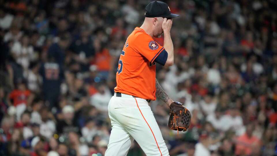 Houston Astros relief pitcher Ryan Pressly (55) reacts after a wild pitch advancing two Seattle Mariners during the eighth inning of an MLB game at Minute Maid Park on Friday, May 3, 2024, in Houston.