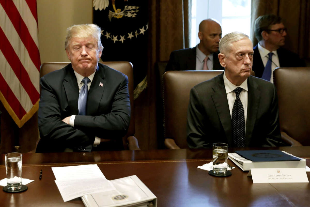 FILE: U.S. President Donald Trump, left, pauses while speaking as James Mattis, US secretary of defense, listens during a Cabinet meeting at the White House in Washington, D.C., U.S., on Thursday, June 21, 2018. Defense Secretary Jim Mattis announced his resignation on Thursday, citing differences over policy with Donald Trump, a day after the president abruptly called for the withdrawal of American forces from Syria. Trump's cabinet and cabinet-level positions have seen far more resignations and dismissals than other recent administrations. Our gallery pulls together Trump's top White House aides that have departed or announced their departure, Bannon, Bossert, Cohn, Flynn, Hicks, Manigault, Mcfarland, McGahn, McMaster, Powell, Priebus, Scaramucci, Short, Spicer, Sessions, Kelly and Mattis. Photographer: Yuri Gripas/Bloomberg