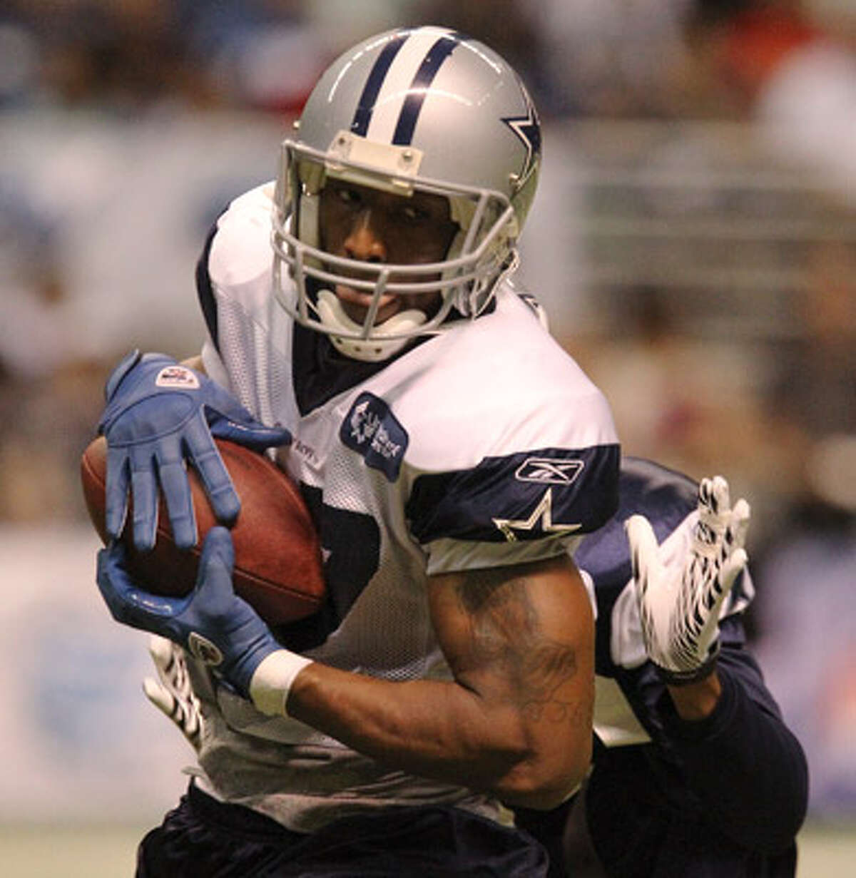 Cowboys receiver Sam Hurd, making a catch during training camp at the Alamodome, only has 31 career catches in four seasons but has made a mark in Dallas on special teams.