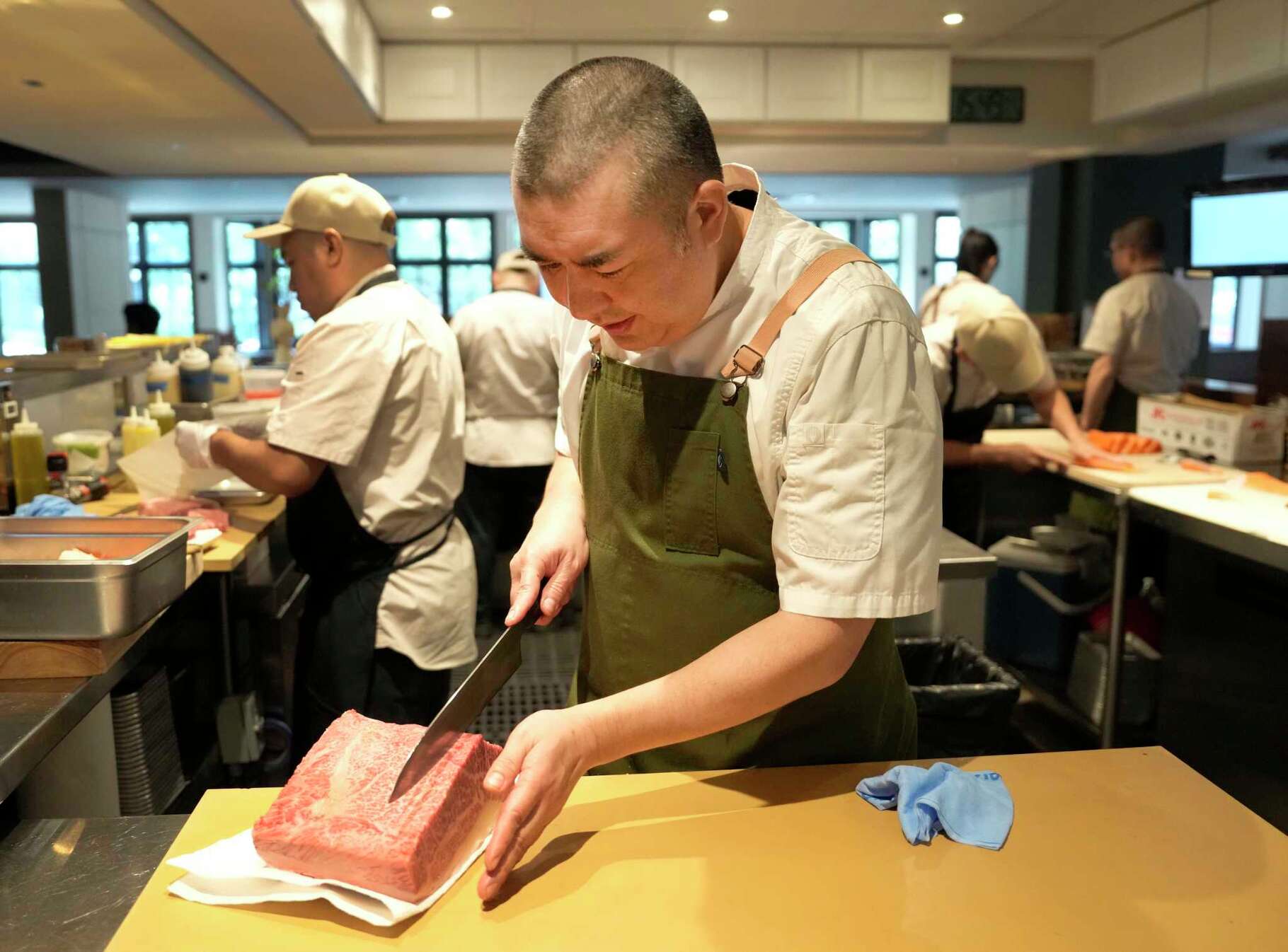 Chef Manabu Horiuchi slices a piece of Matsusaka wagyu at Katami, 2701 West Dallas St., Wednesday, May 8, 2024, in Houston.